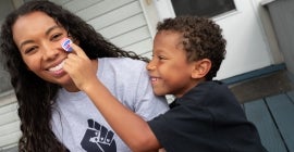 photo of Black mother and her son smiling