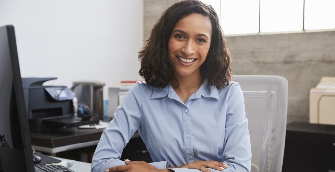 dark skinned woman at desk