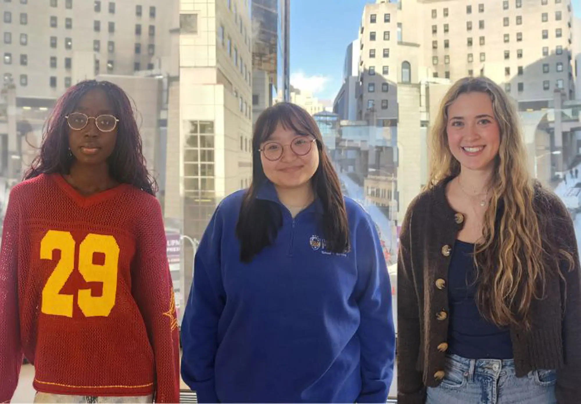 Three female students pose for a picture.