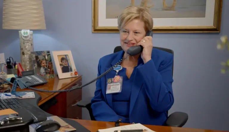 Helene Burns talking on the phone in an office