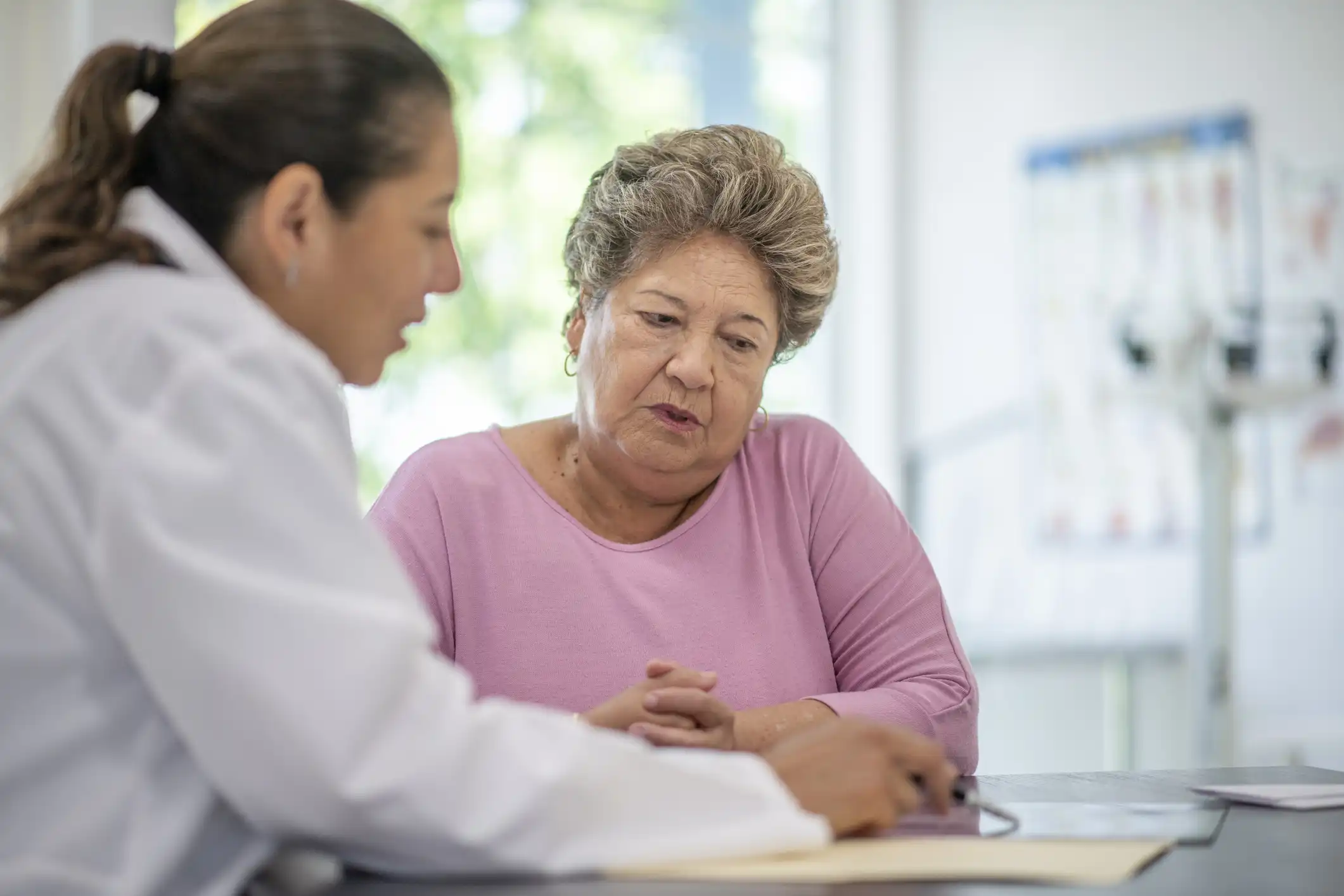 Nurse speaks with adult patient