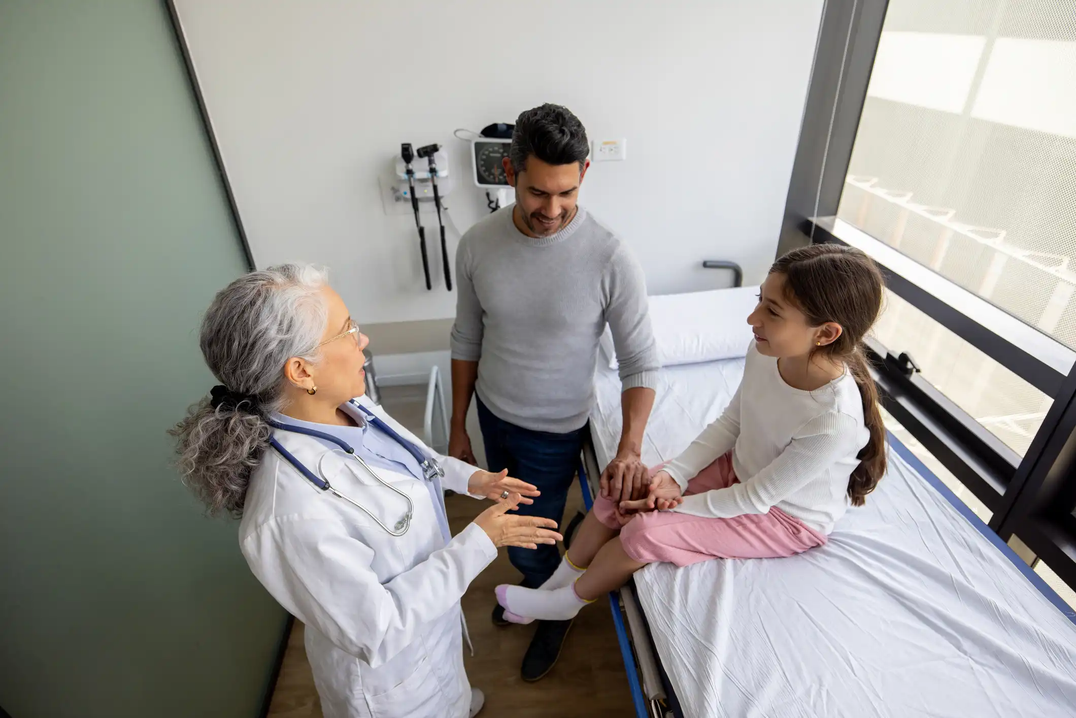 Nurse talking with pediatric patient and parent