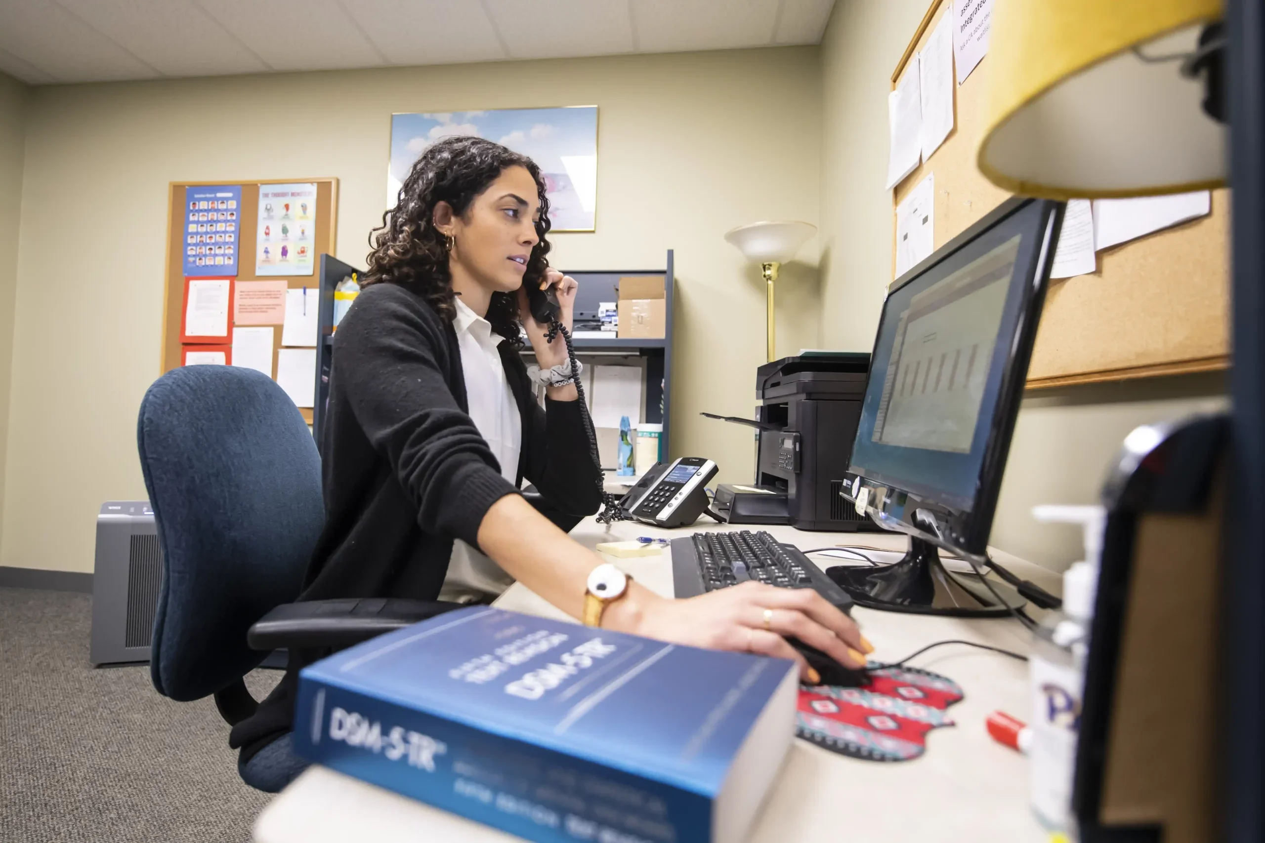 Psych student at computer in office